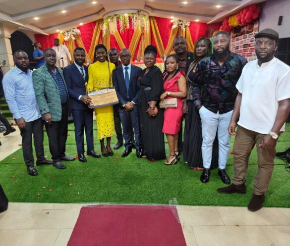 Ams staff posing with their latest award trailblazing quality cocoa production