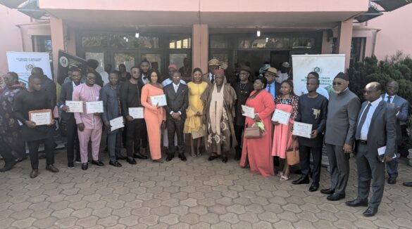 Board members in a photo with young professional graduates and Administration